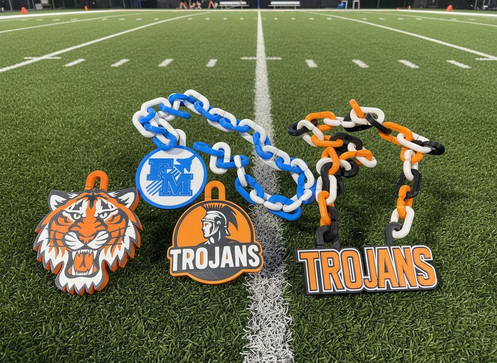 Decorative chain with tiger and 'Trojans' logos on a black background